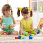 children-playing-together-building-blocks-educational-toys-preschool-kindergarten-kids-little-girls-build-toys-h-90711453
